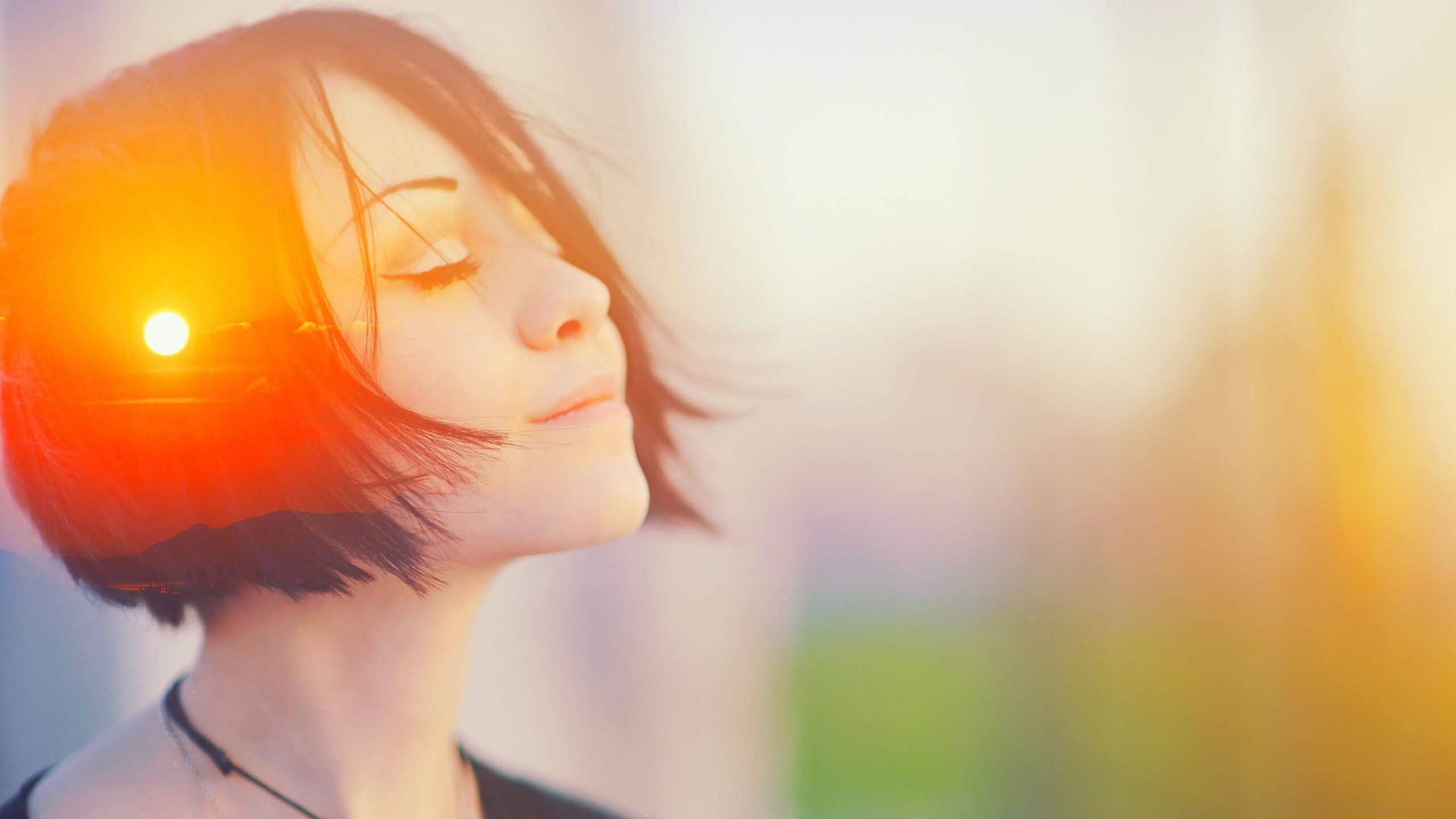 A woman looking at peace with the sun in her hair